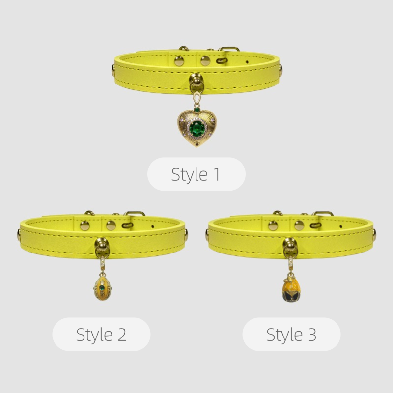 Three styles of yellow dog collars with heart-shaped charms on a white background