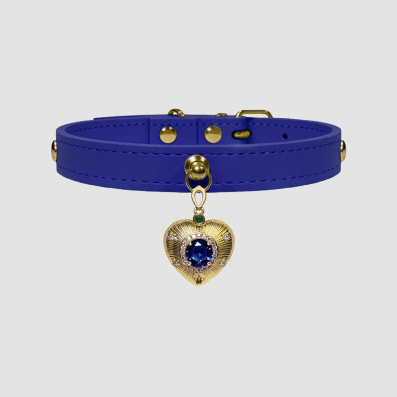 Blue leather choker with a gold heart-shaped charm on a light gray background