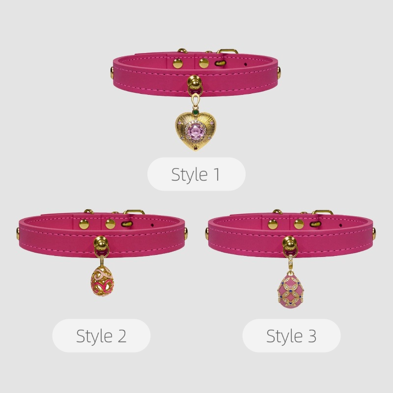 Three styles of pink dog collars with heart and teardrop charms on a light gray background.