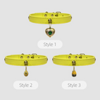Three styles of yellow dog collars with heart-shaped charms on a white background
