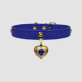 Blue leather choker with a gold heart-shaped charm on a light gray background