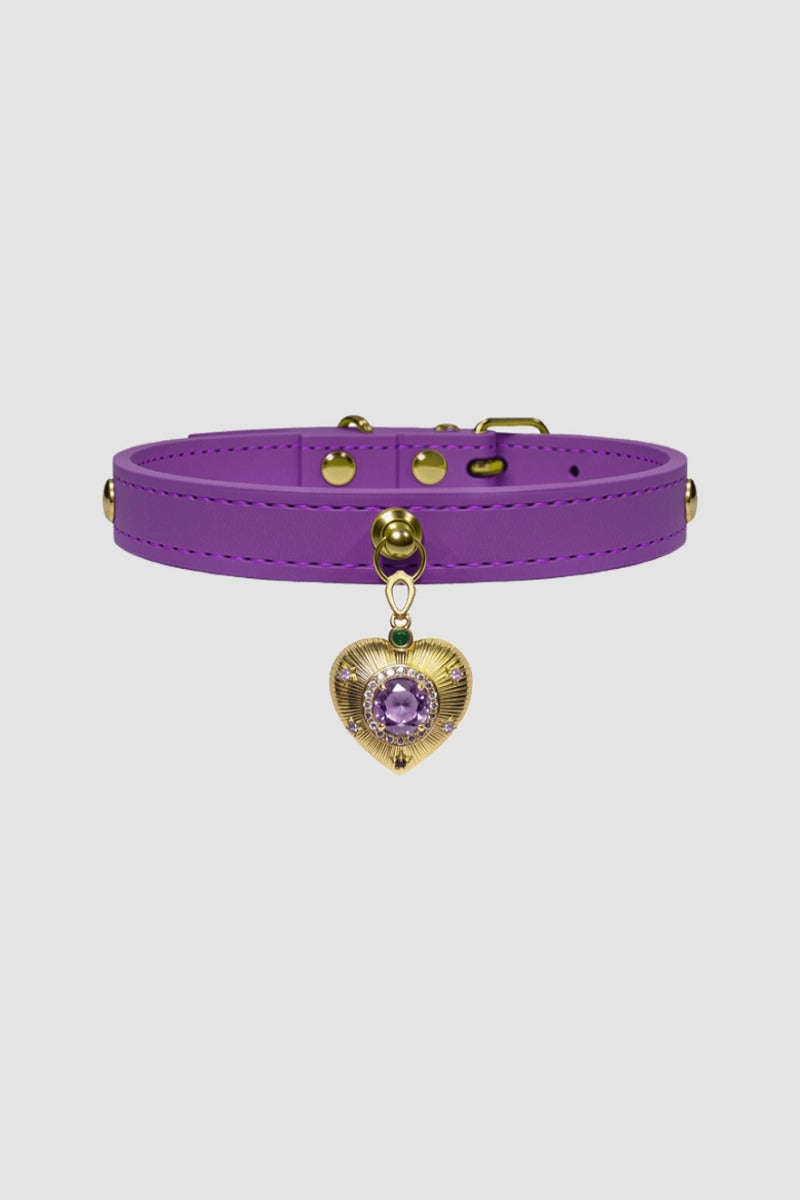 Purple choker with a gold heart-shaped charm on a light gray background