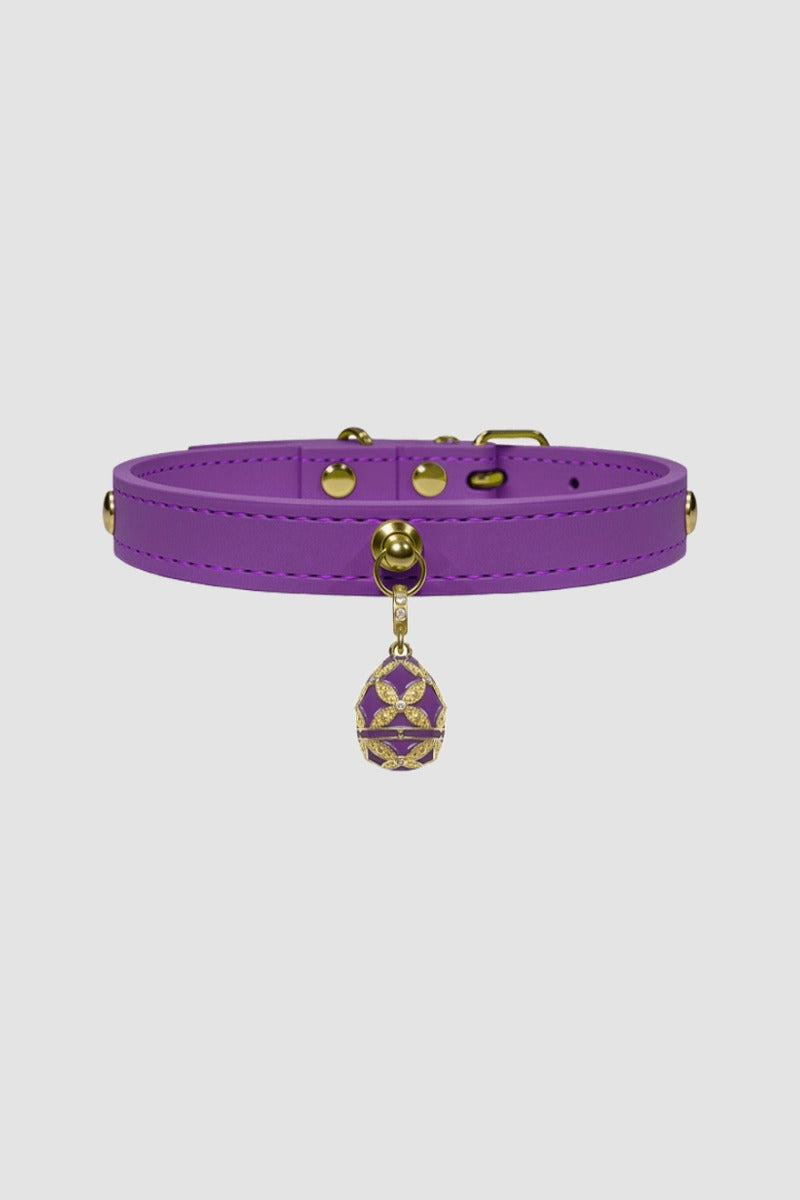 Purple leather choker with gold accents on a light gray background